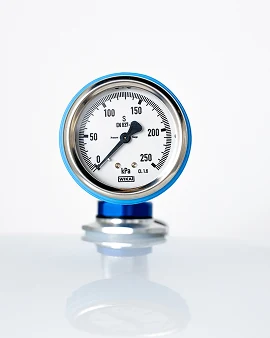A pressure gauge on a polished hyperbaric fitting.